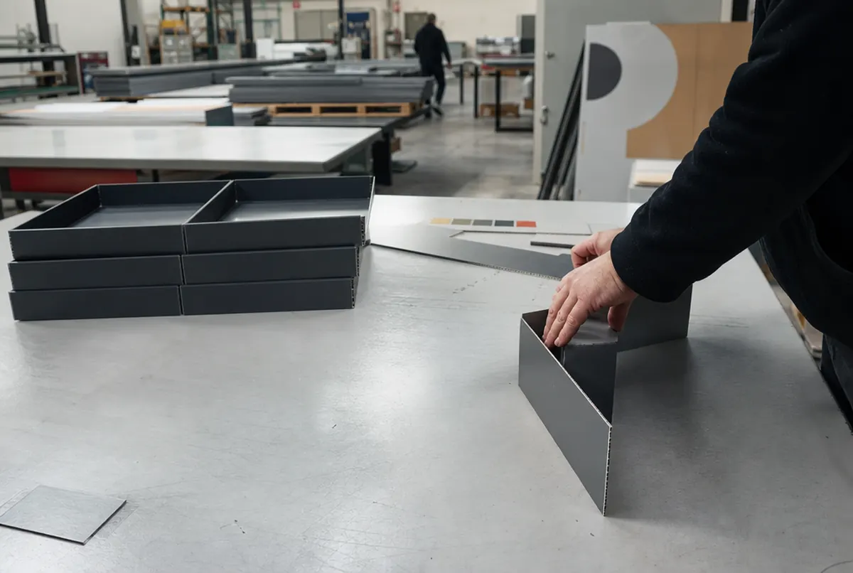 Folding V-cut aluminium composite into a neat box shape on the workbench